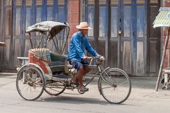 man pedaling rickshaw