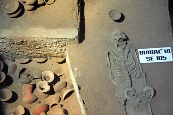 skeleton and pottery in a burial site