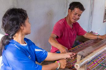 couple weaving sitting mat