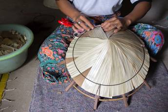 woman making bamboo hat