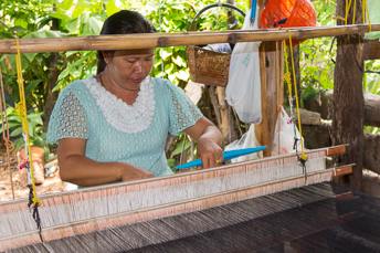 woman sitting at silk-weaving loom