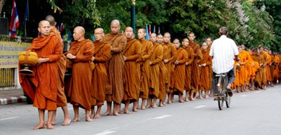 row of monks collecting alms