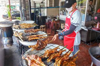 man grilling chicken