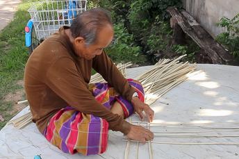 man weaving bamboo