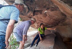 guide showing guests cave paintings