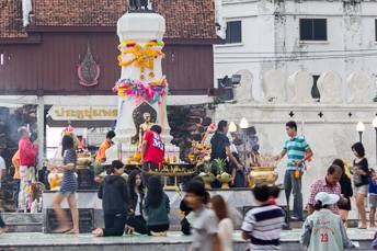 crowd of people making offerings at a shrine