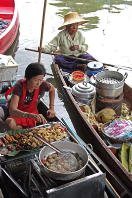 two women selling food from boats