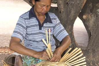 woman weaving bamboo